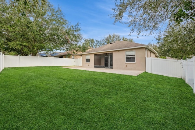 back of house with a yard and a patio area