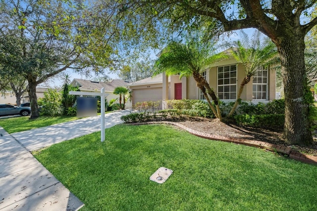 view of front of house with a garage and a front yard