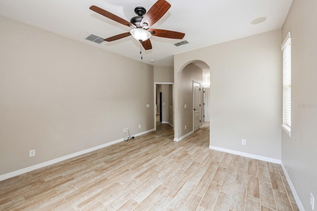 empty room with ceiling fan and light wood-type flooring