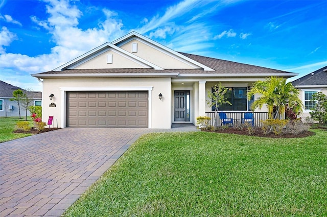 ranch-style home featuring a garage, a front lawn, and covered porch