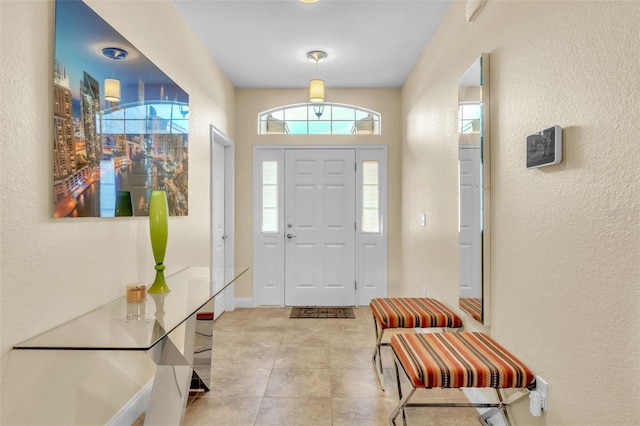 foyer entrance featuring light tile patterned floors