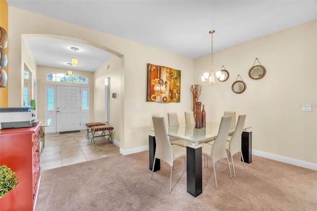 carpeted dining area with a notable chandelier