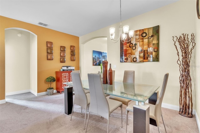 dining room featuring an inviting chandelier and light colored carpet