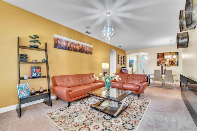 carpeted living room with a notable chandelier