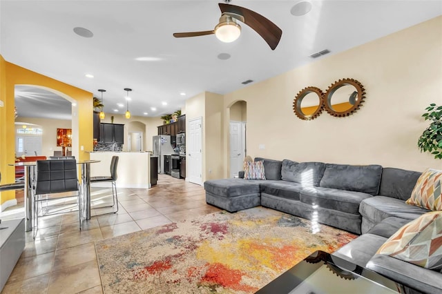 living room featuring ceiling fan and light tile patterned floors