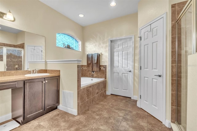 bathroom featuring vanity, tile patterned flooring, and separate shower and tub