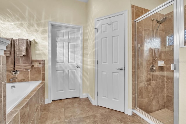 bathroom featuring independent shower and bath and tile patterned flooring