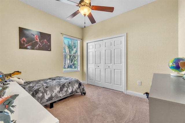 carpeted bedroom with a closet and ceiling fan