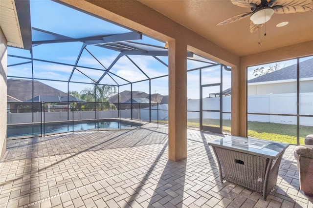 view of pool featuring ceiling fan, a lanai, and a patio area