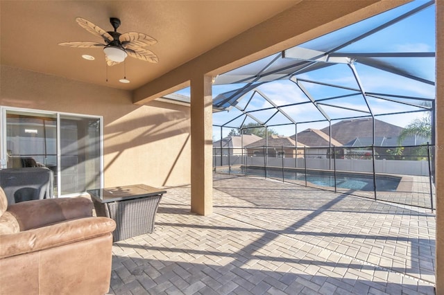 view of patio / terrace with a fenced in pool, a lanai, and ceiling fan