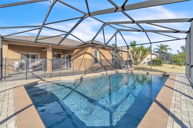 view of pool featuring a patio, a lanai, and ceiling fan