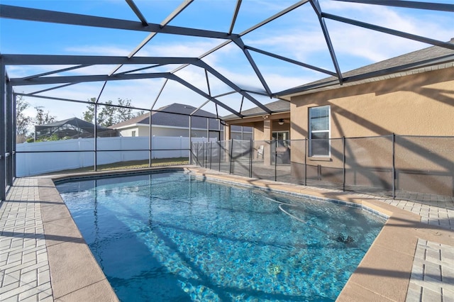 view of swimming pool featuring a lanai and a patio area