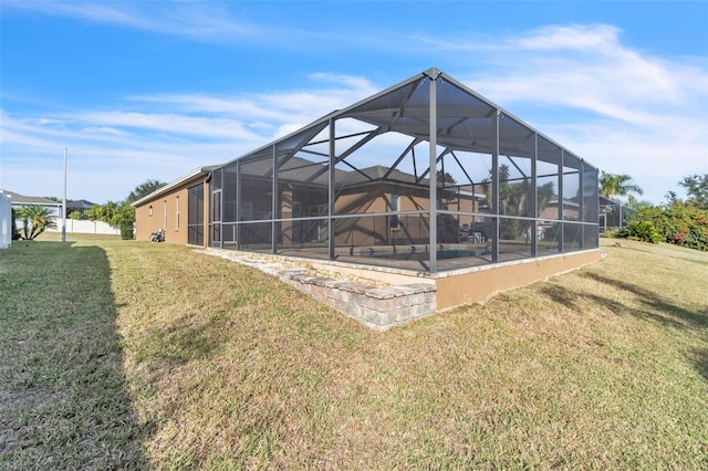 back of house with a pool, a yard, and glass enclosure