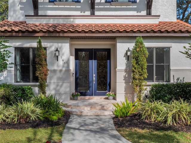 view of exterior entry featuring french doors