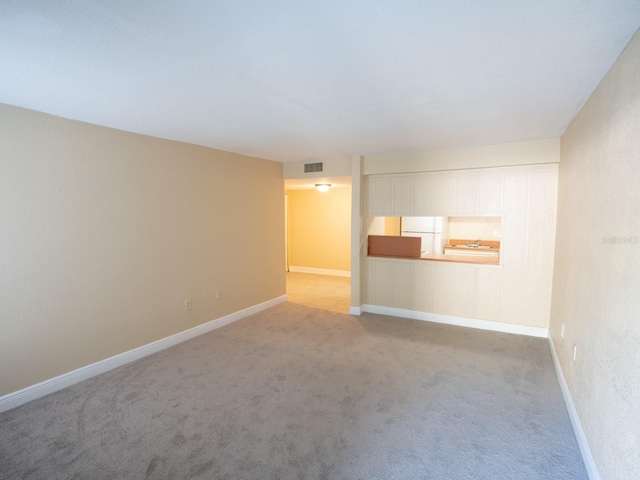 unfurnished room with light carpet