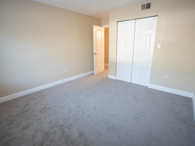 unfurnished bedroom featuring a closet and carpet