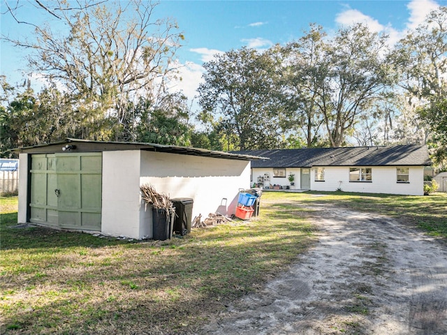 exterior space featuring a front yard and an outdoor structure