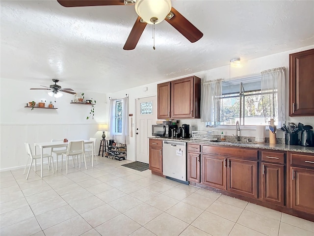 kitchen with dishwasher, light stone countertops, a textured ceiling, black microwave, and a sink