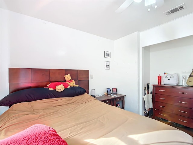 bedroom with ceiling fan and visible vents