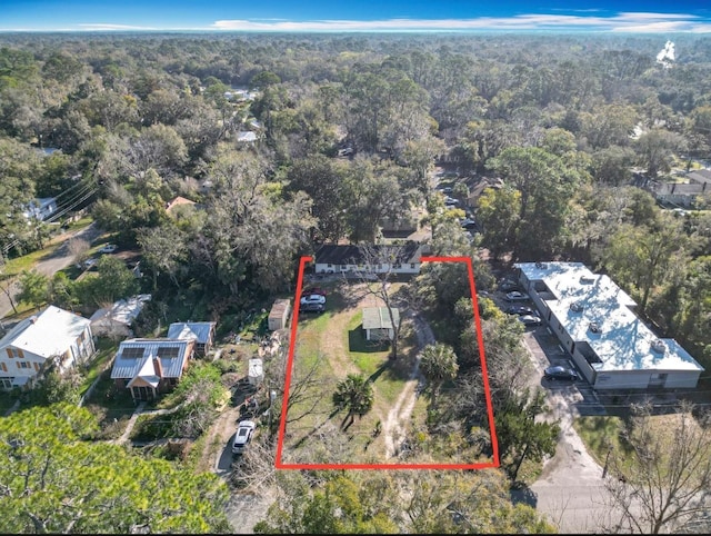 drone / aerial view featuring a wooded view