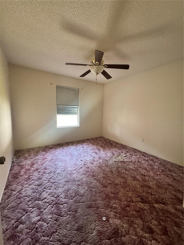 unfurnished room with ceiling fan and carpet flooring