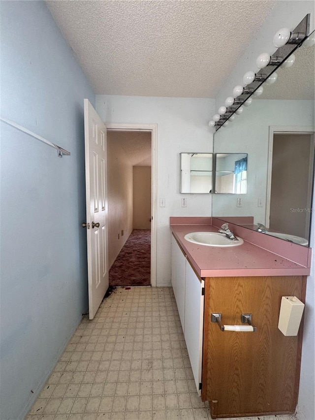 bathroom featuring vanity and a textured ceiling