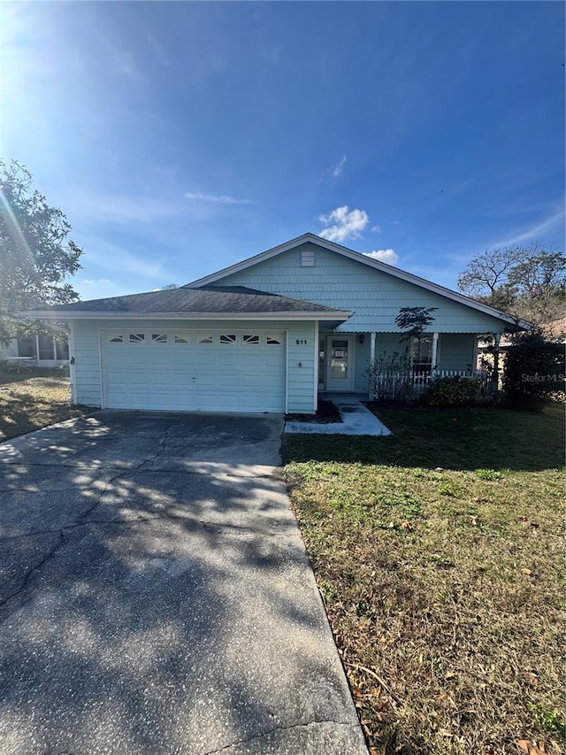 single story home featuring a garage and a front yard