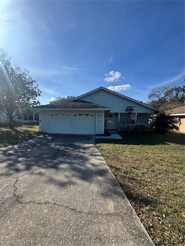 view of front of home featuring a garage and a front lawn