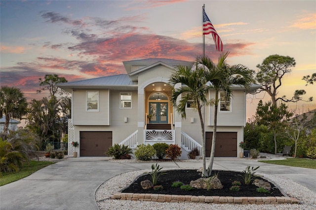 view of front of home with a garage and french doors