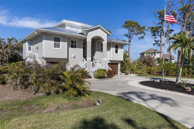 view of front of house featuring a garage and a front lawn