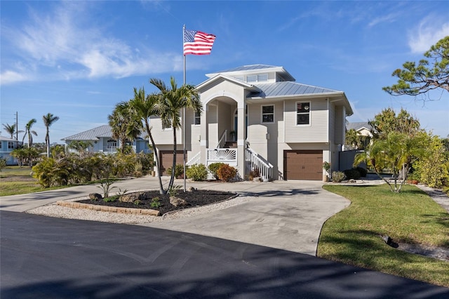 view of front of home with a garage and a front lawn