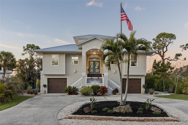 view of front facade with a garage and french doors