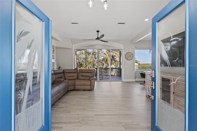 sunroom / solarium featuring ceiling fan