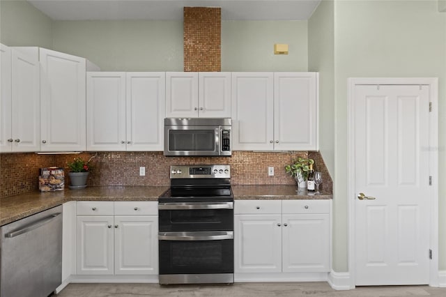 kitchen with white cabinetry, appliances with stainless steel finishes, and tasteful backsplash