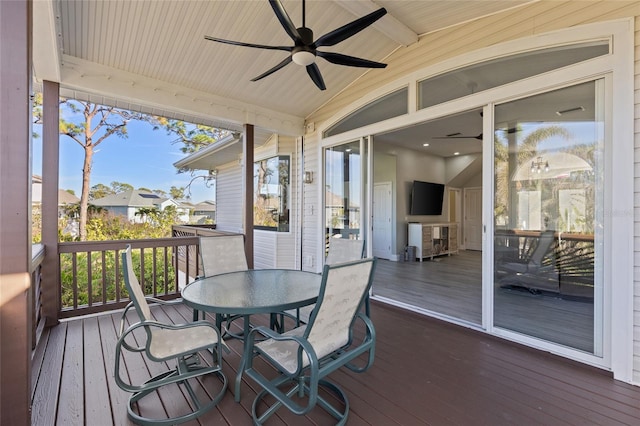 sunroom with vaulted ceiling with beams and ceiling fan