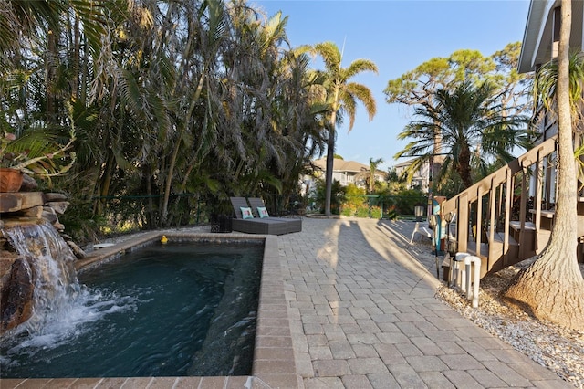 view of swimming pool featuring a patio and pool water feature