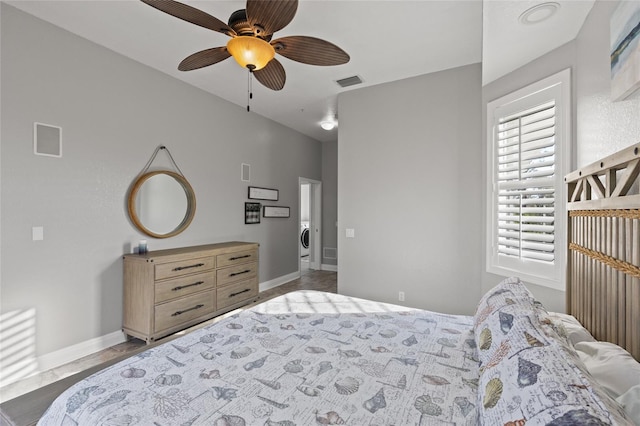 bedroom featuring washer / clothes dryer and ceiling fan