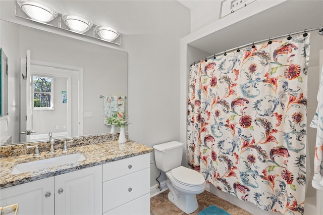 bathroom featuring vanity, curtained shower, tile patterned floors, and toilet