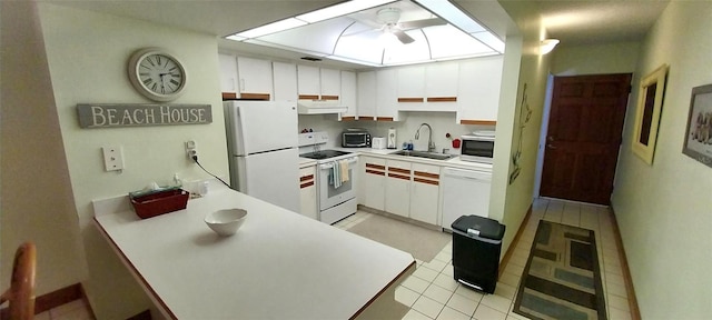 kitchen featuring white appliances, sink, and white cabinets