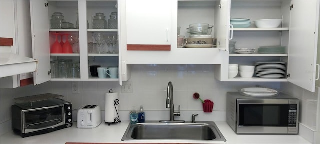 kitchen featuring tasteful backsplash and sink