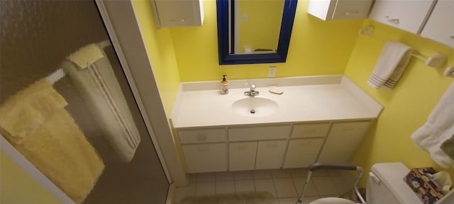 bathroom featuring tile patterned flooring, vanity, and toilet