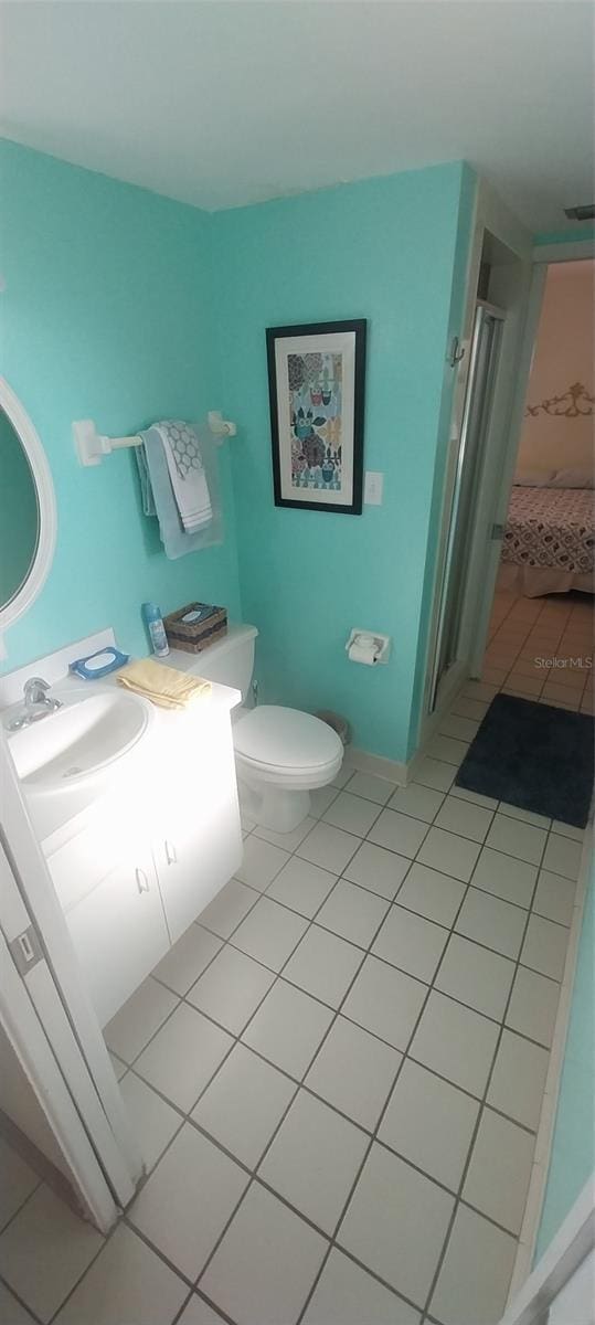 bathroom featuring vanity, toilet, and tile patterned flooring