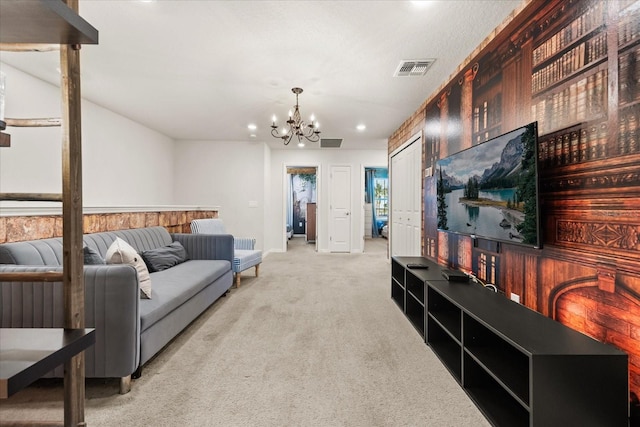 carpeted living room with a chandelier