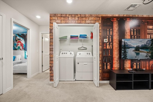 laundry area featuring carpet flooring and washing machine and dryer