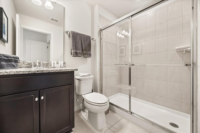 bathroom featuring an enclosed shower, vanity, tile patterned floors, and toilet