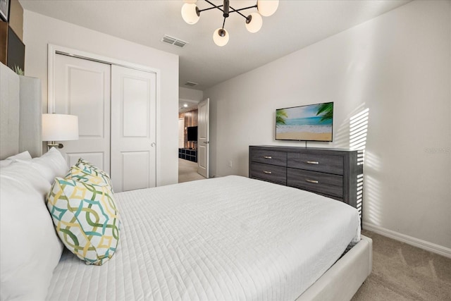 carpeted bedroom featuring a notable chandelier and a closet