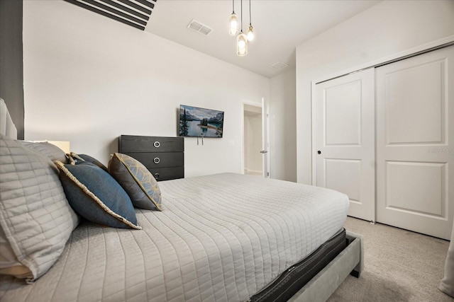 bedroom with light colored carpet and a closet