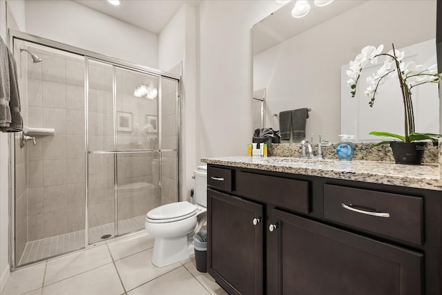 bathroom with walk in shower, tile patterned floors, vanity, and toilet