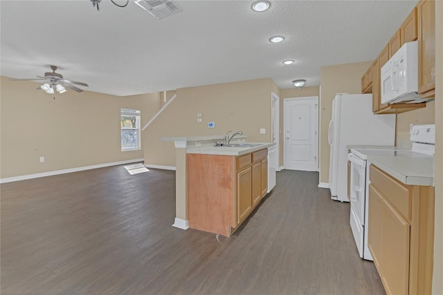 kitchen with light brown cabinetry, sink, a center island with sink, dark hardwood / wood-style flooring, and white appliances