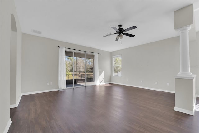 unfurnished living room with dark wood-type flooring, ceiling fan, and ornate columns